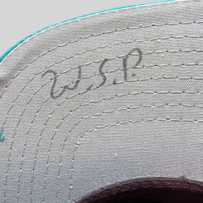 Raree Finds vintage 90s Anaheim Mighty Ducks snapback hat showing initials written on the gray undervisor