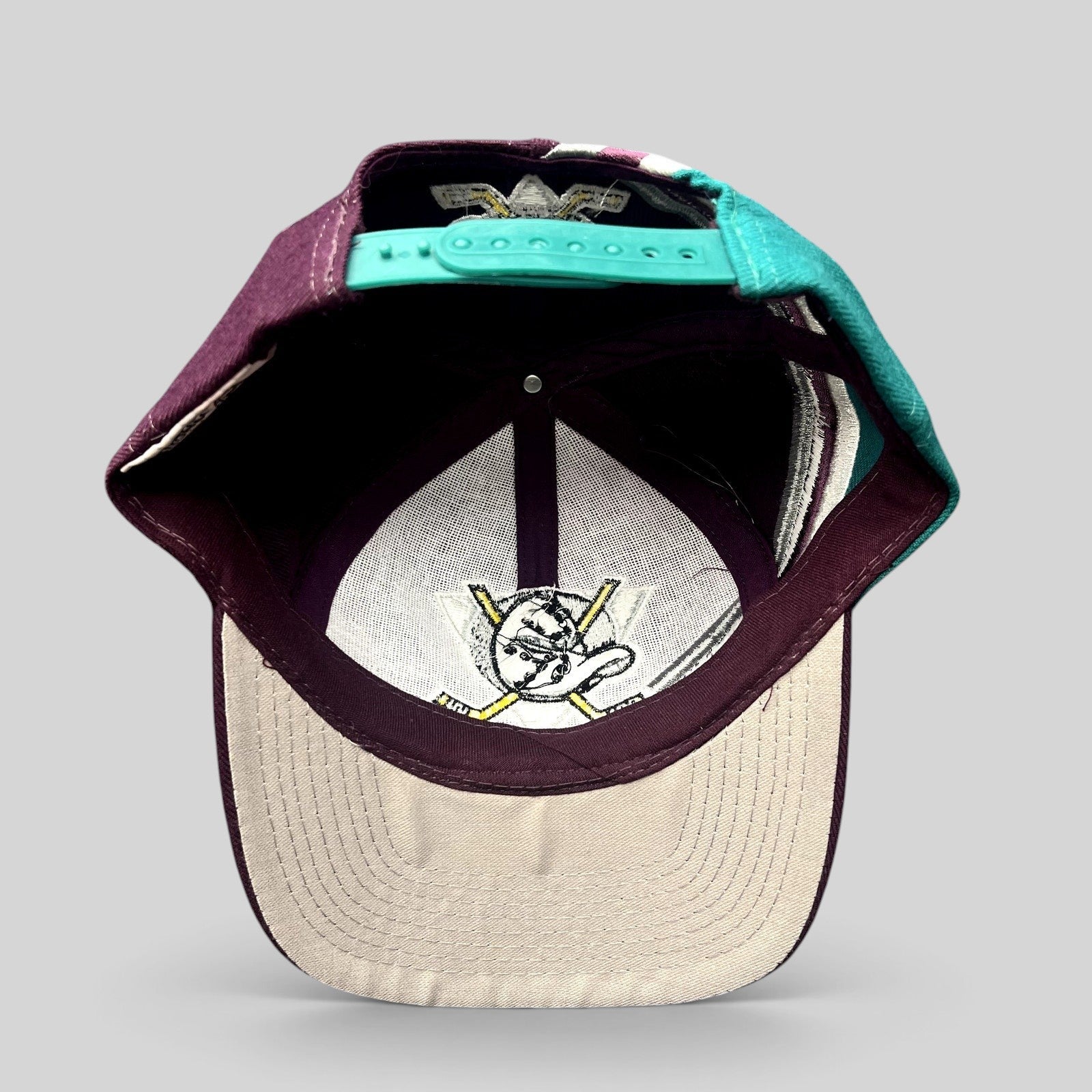 Raree Finds vintage Anaheim Mighty Ducks Apex One snapback hat interior view showing logo and teal adjustable strap