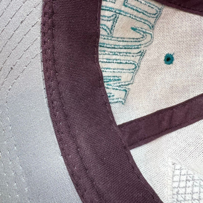 Raree Finds vintage 90s Anaheim Mighty Ducks Starter snapback hat interior showing eggplant crown and gray undervisor