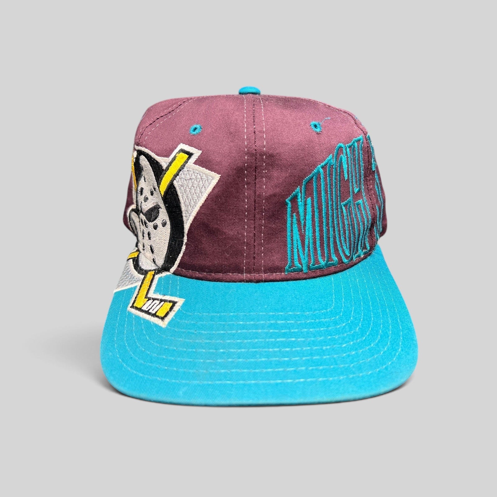 Raree Finds vintage 90s Anaheim Mighty Ducks Starter snapback hat with eggplant crown, teal brim, and script logo.