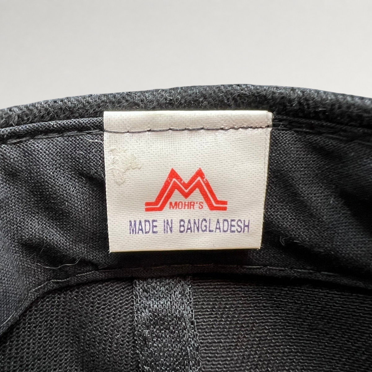 Raree Finds vintage Mission Impossible 2 hat interior tag showing Mohr's branding and Made in Bangladesh label.