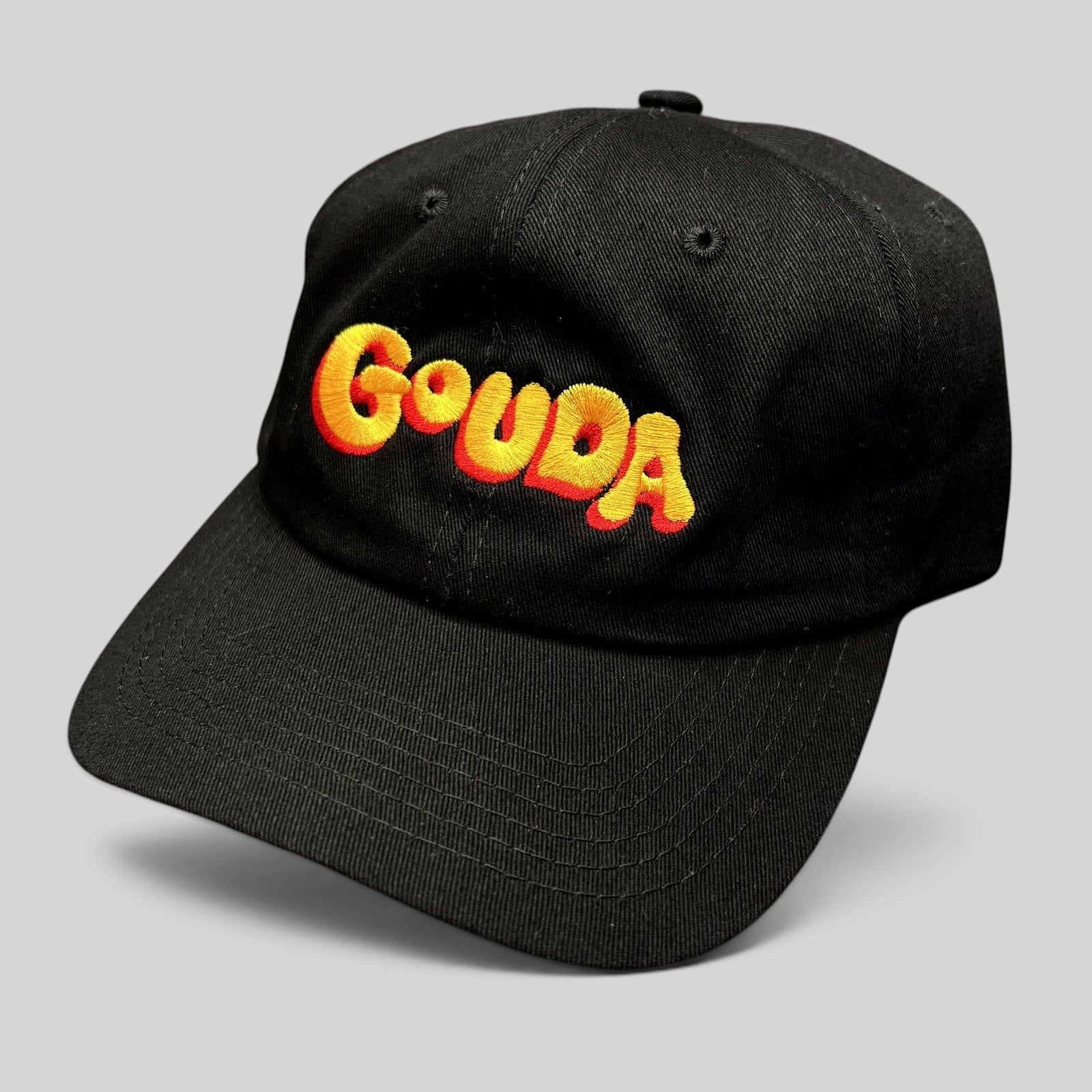 Raree Finds black cotton strapback hat by Mister Parmesan featuring colorful embroidered Gouda text on the front
