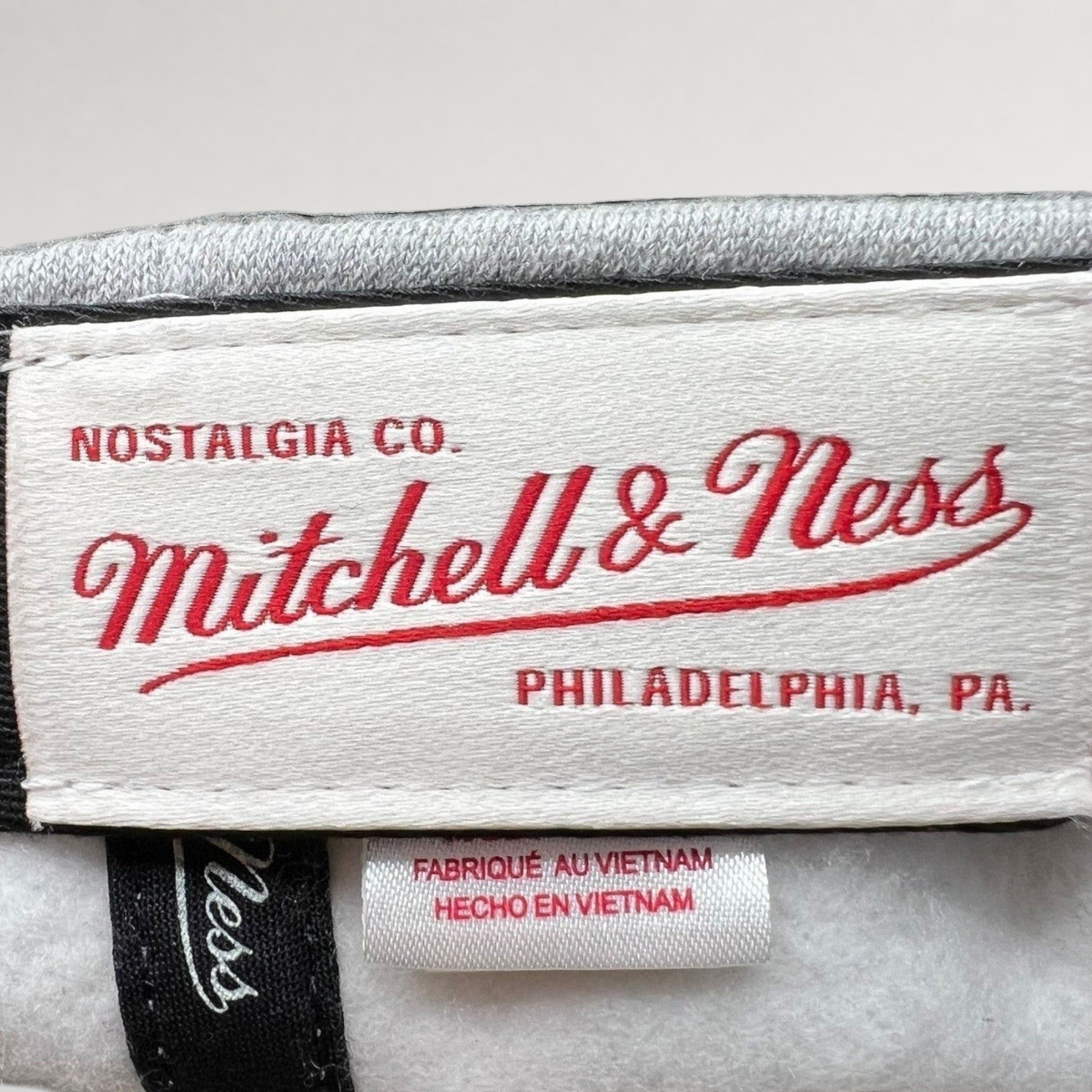 Raree Finds Mitchell & Ness Nostalgia Co. interior brand label and Vietnam origin tag inside a Cavaliers snapback hat.