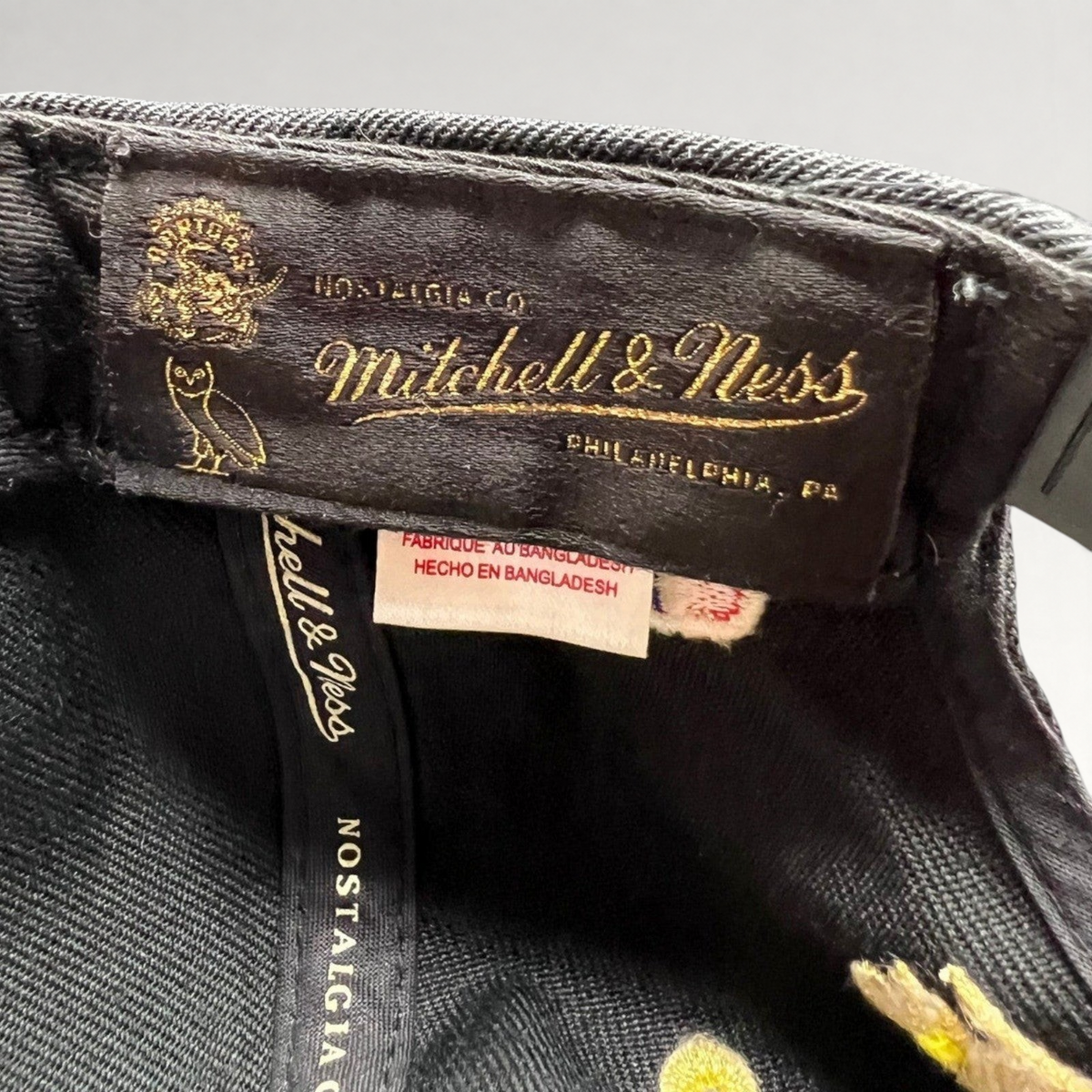 Raree Finds Mitchell & Ness x OVO Toronto Raptors snapback interior label with gold embroidery on black fabric