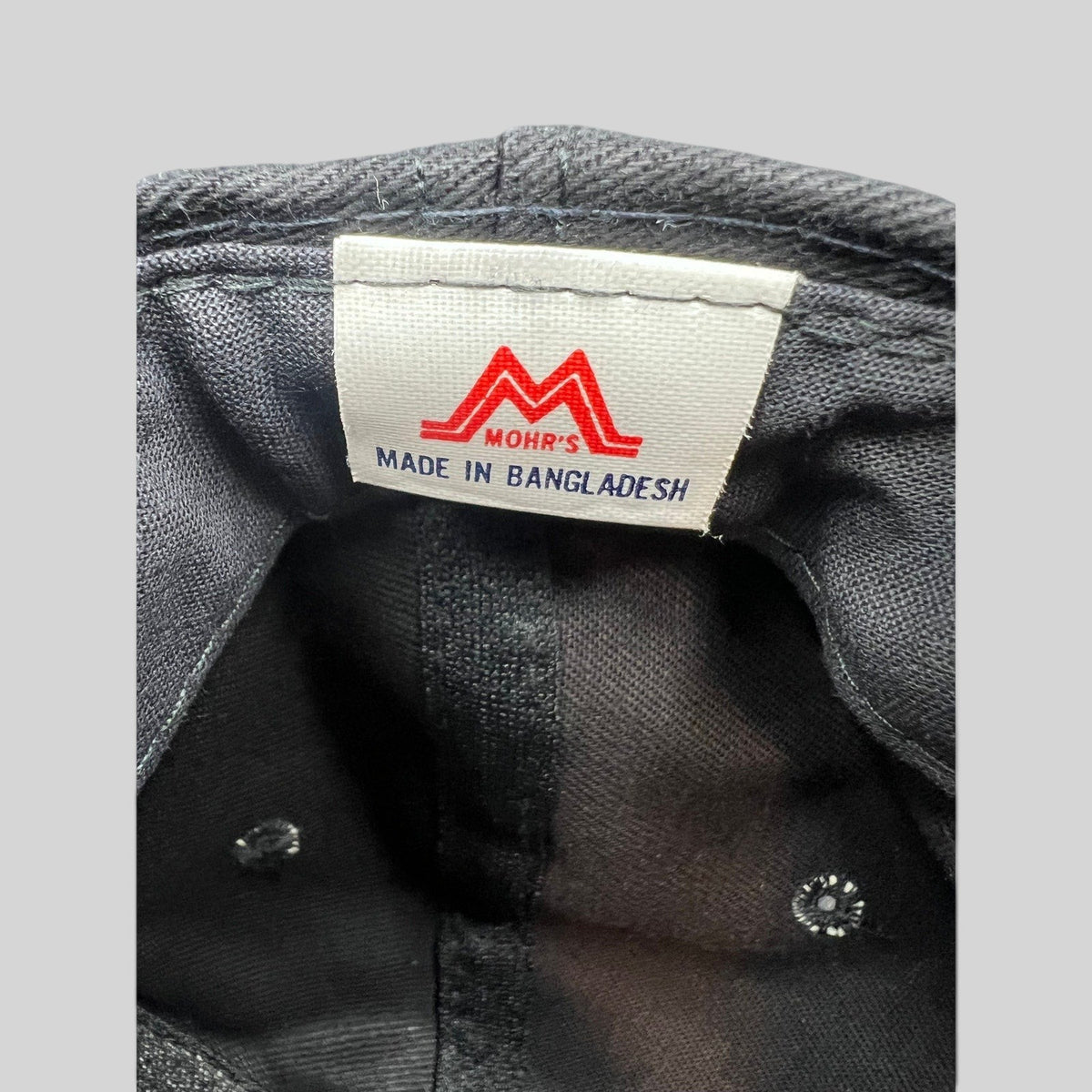Raree Finds vintage 90s Mohr's hat interior label showing brand logo and Made in Bangladesh text on black cotton
