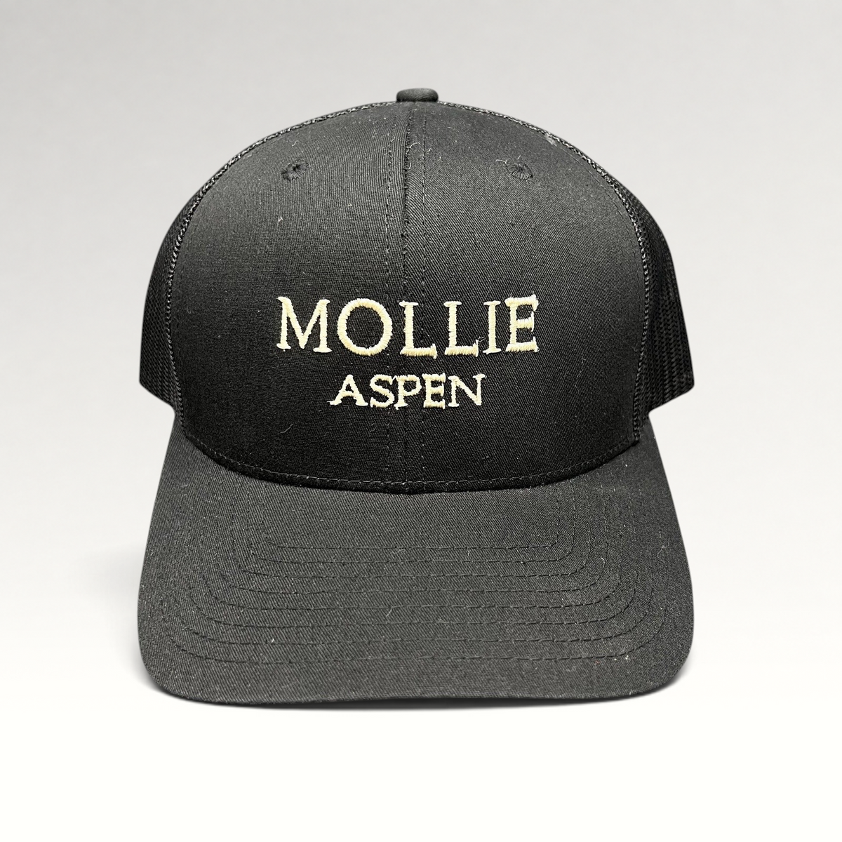 Raree Finds black MOLLIE Aspen Yupoong Classics trucker hat with embroidered logo and breathable mesh back panels