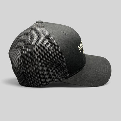 Raree Finds black MOLLIE Aspen trucker hat with breathable mesh back, structured front, and adjustable snapback closure.