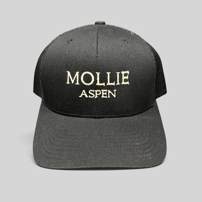 Raree Finds black Yupoong Classics trucker hat with MOLLIE Aspen embroidered logo and breathable mesh back panels