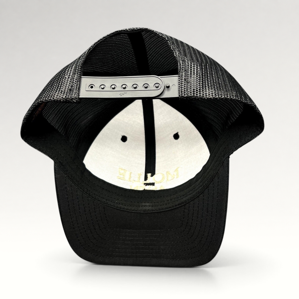 Raree Finds MOLLIE Aspen black trucker hat showing the adjustable snapback closure and breathable mesh back panels