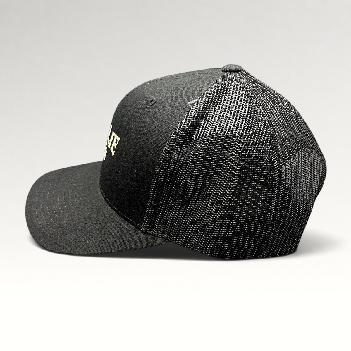 Raree Finds black MOLLIE Aspen Yupoong Classics trucker hat with breathable mesh back and adjustable snapback closure