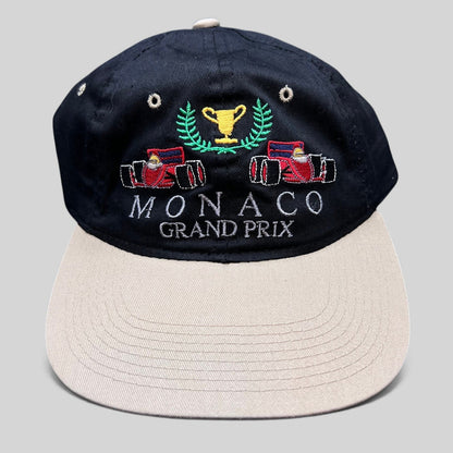 Raree Finds vintage Monaco Grand Prix racing hat with black crown, beige brim, and embroidered F1 race car graphic.