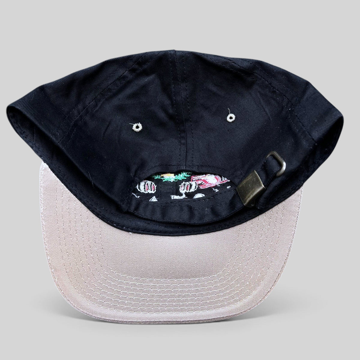 Raree Finds vintage Monaco Grand Prix racing hat with black crown, beige brim, and adjustable metal strapback closure.