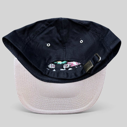 Raree Finds vintage Monaco Grand Prix racing hat with black crown, beige brim, and adjustable metal strapback closure.