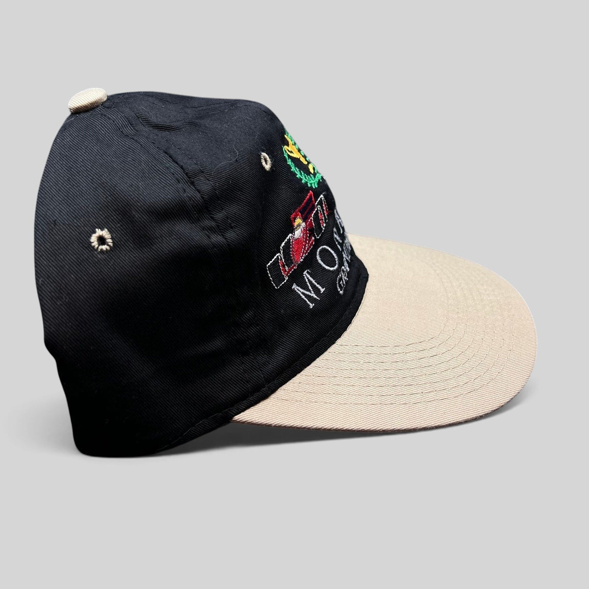 Raree Finds vintage Monaco Grand Prix racing hat with black crown, beige brim, and embroidered Formula One graphics.
