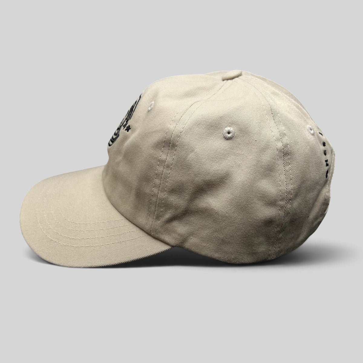 Raree Finds Monopoly GO cream strapback hat with curved brim and embroidered front logo in a side profile view
