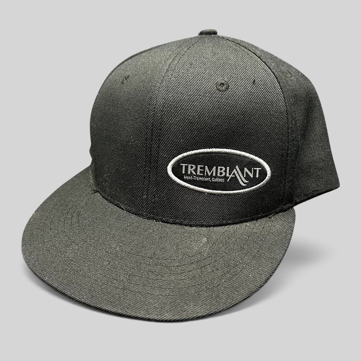 Raree Finds black Fits snapback hat featuring an embroidered oval Mont Tremblant Quebec ski resort logo on the front.