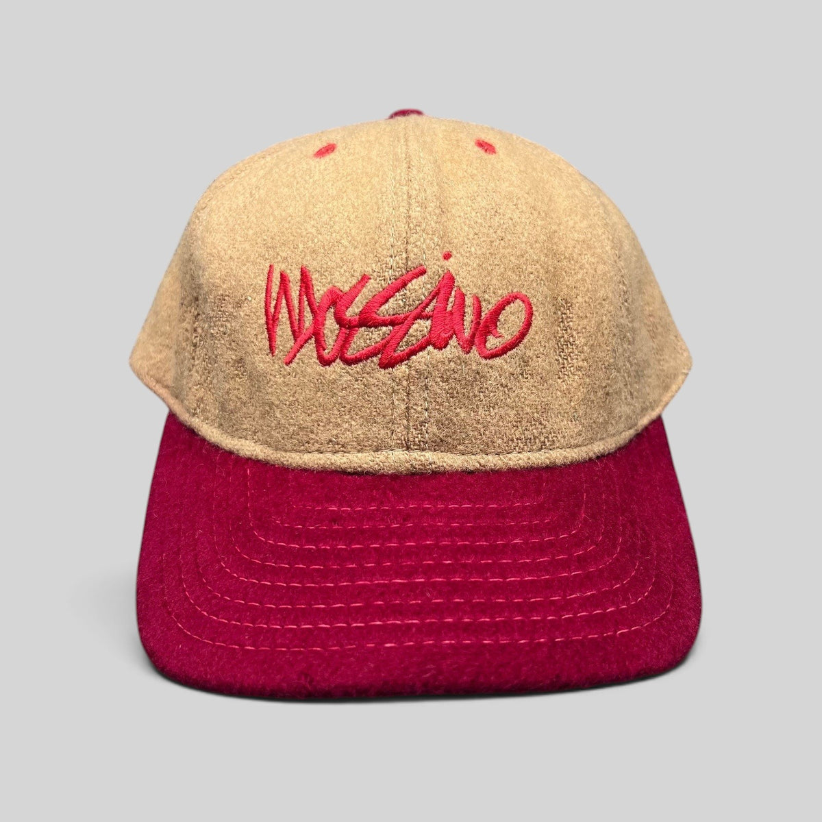 Raree Finds vintage Mossimo wool snapback hat in camel and red with embroidered script logo, front view.