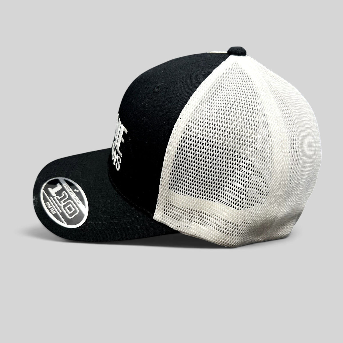 Raree Finds The Movie Guys black and white Flexfit 110 trucker hat with embroidered logo and breathable mesh back