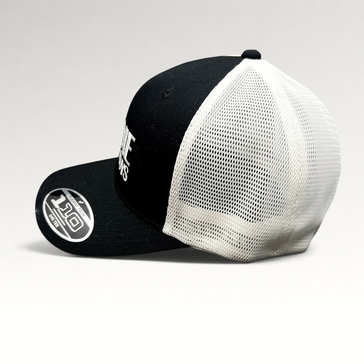 Raree Finds The Movie Guys black and white Flexfit 110 trucker hat with embroidered logo and breathable mesh back