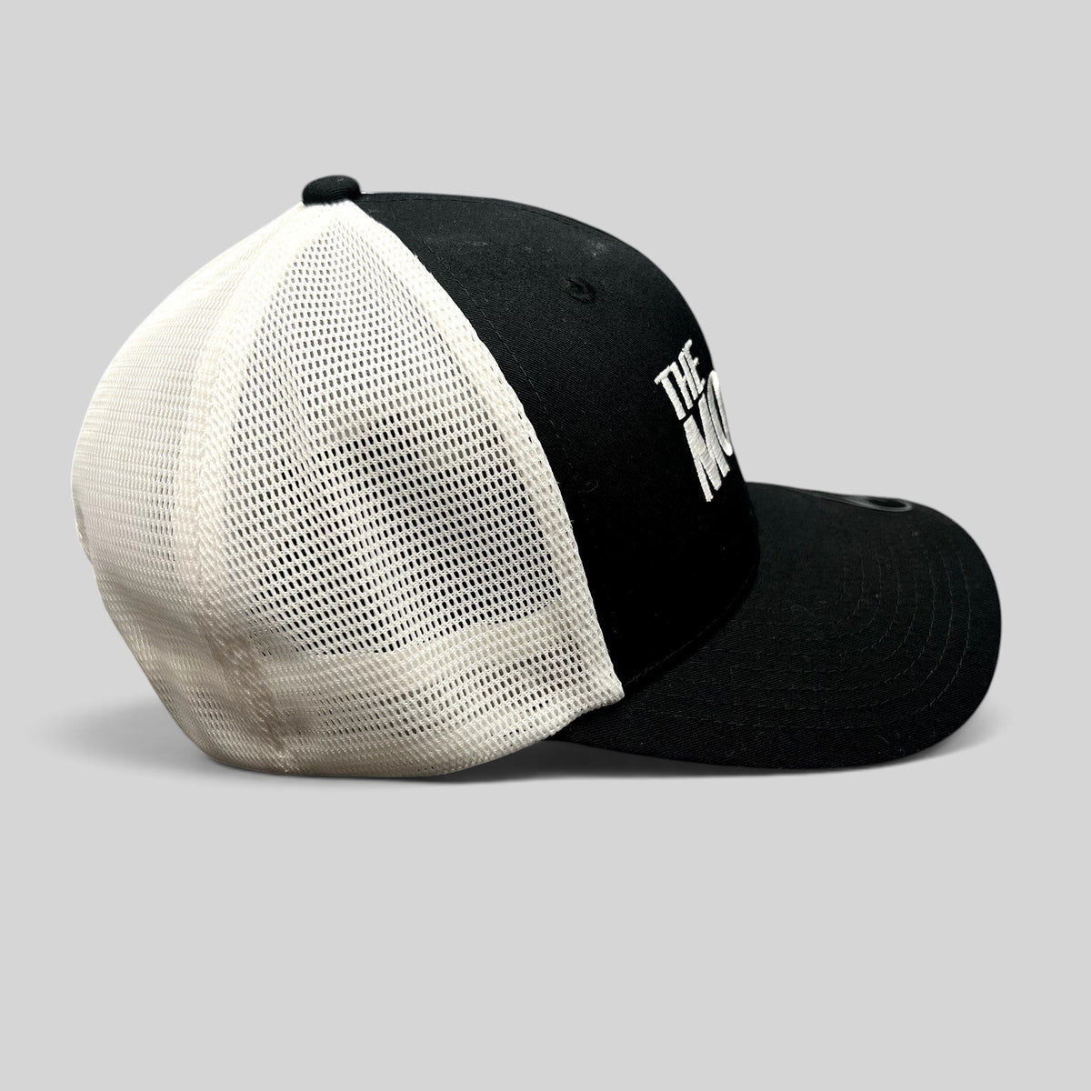 Raree Finds The Movie Guys black and white trucker hat with embroidered logo and breathable mesh back panels