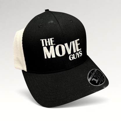 Raree Finds black and white The Movie Guys trucker hat with embroidered logo and breathable mesh back panels.