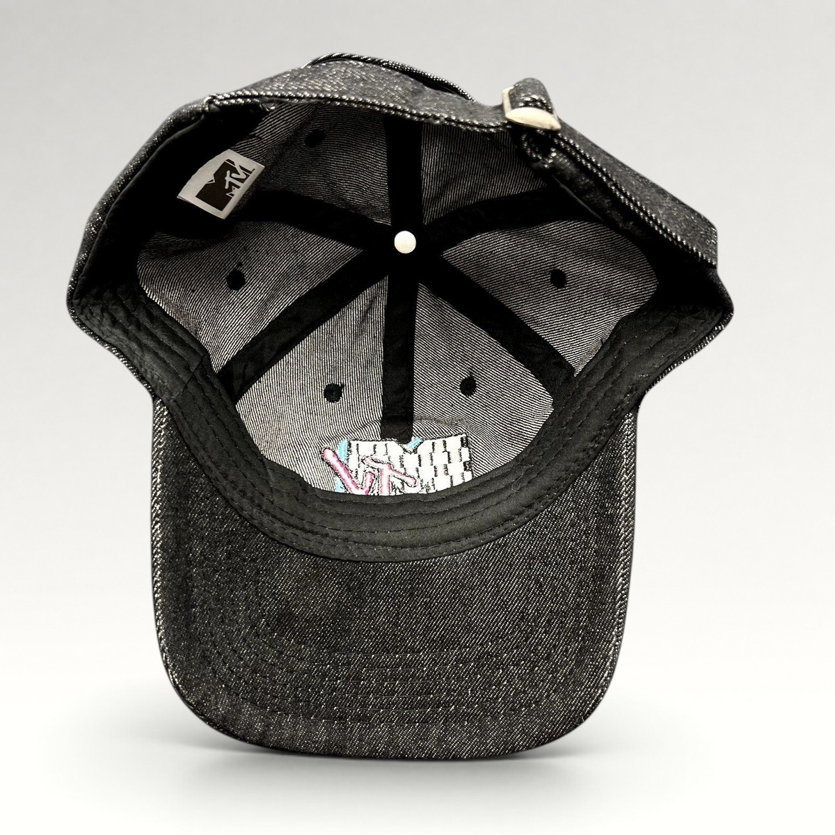 Raree Finds black MTV strapback hat interior showing six-panel construction, embroidered logo, and adjustable strap.