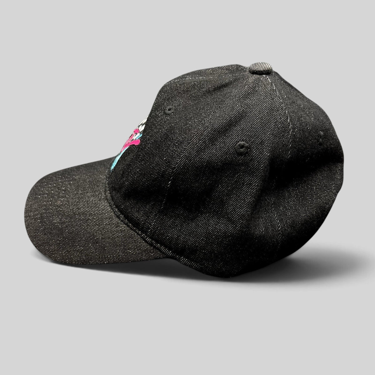 Raree Finds black MTV Music Television strapback hat with embroidered logo and checkered detail, side view.