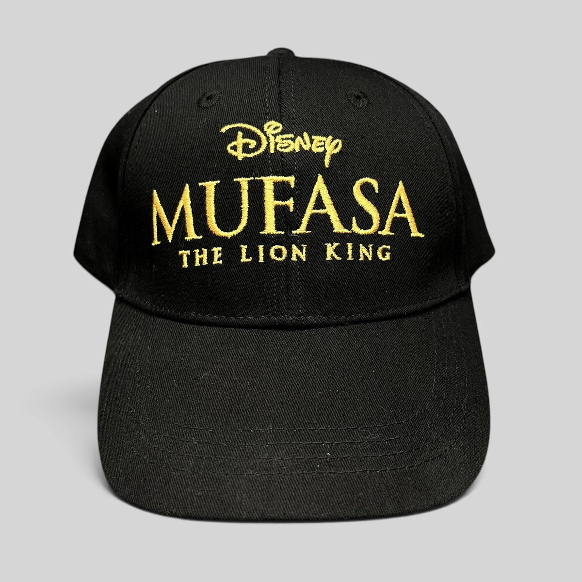 Raree Finds Disney Mufasa The Lion King 2024 promo strapback hat in black cotton with gold embroidered front logo.