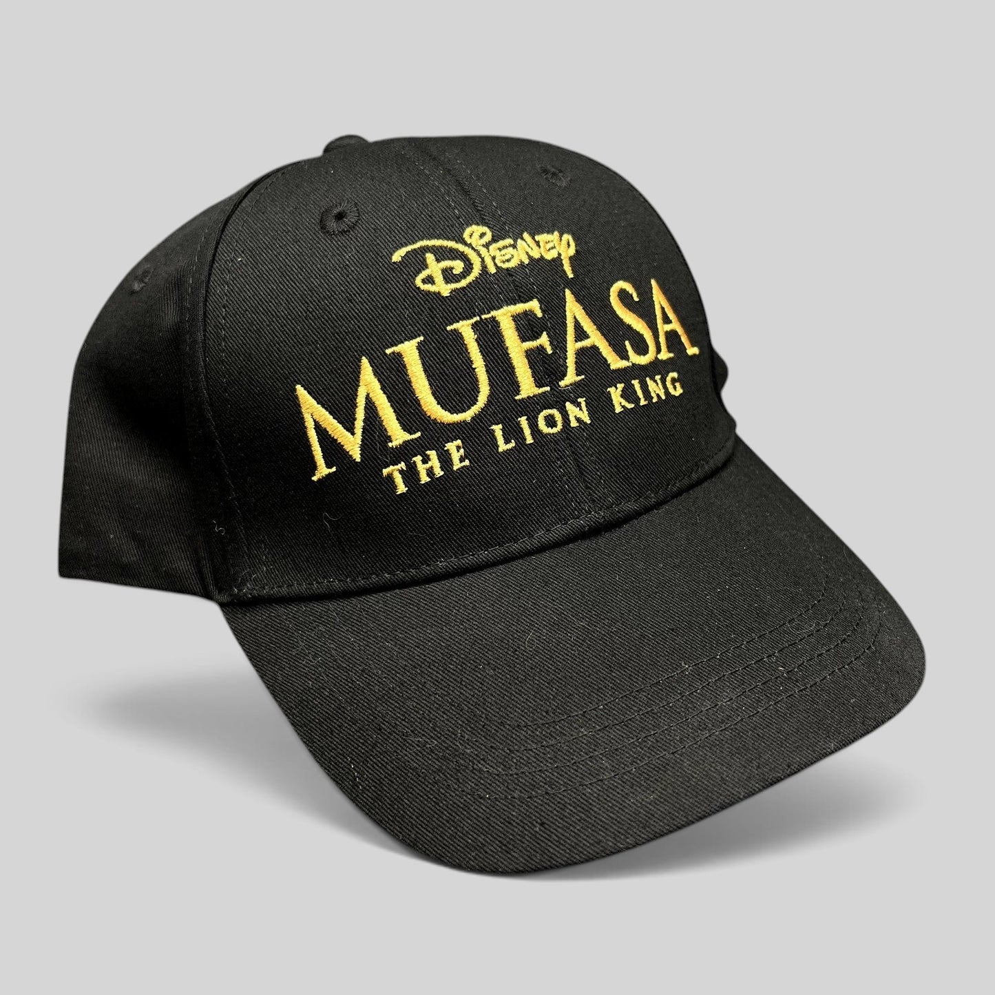 Raree Finds black cotton strapback hat featuring gold embroidered Mufasa The Lion King 2024 movie logo