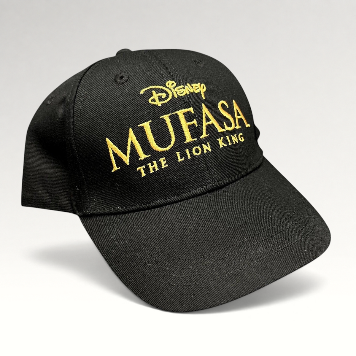 Raree Finds black cotton strapback hat featuring gold embroidered Mufasa The Lion King 2024 movie logo