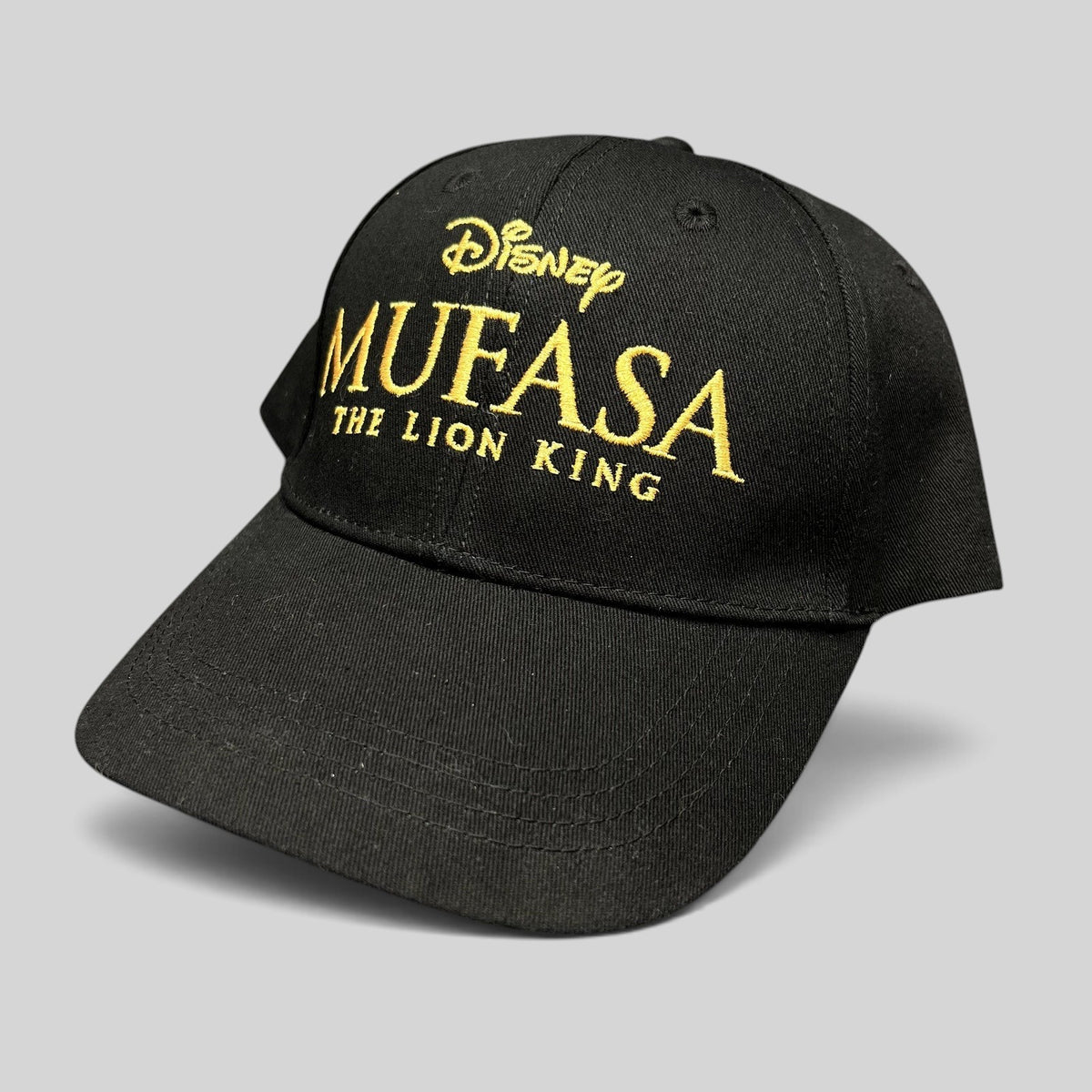 Raree Finds Disney Mufasa The Lion King 2024 promotional black cotton strapback hat with gold embroidered lettering.