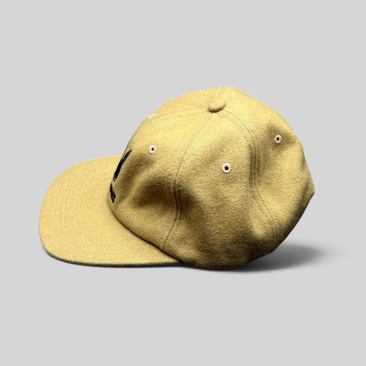 Raree Finds mustard Melton wool strapback hat with black embroidered Playboy Bunny logo and curved brim