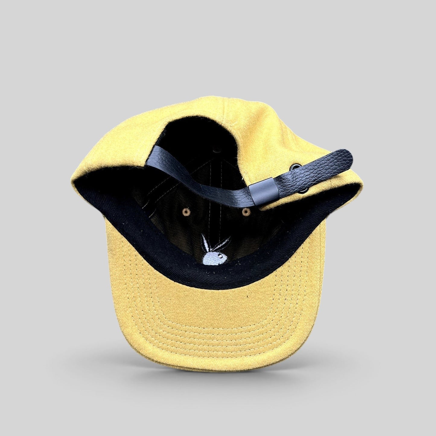 Raree Finds PLEASURES x Playboy mustard wool strapback hat with black leather strap and embroidered bunny logo