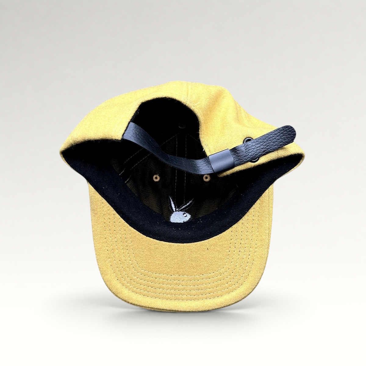 Raree Finds PLEASURES x Playboy mustard wool strapback hat with black leather adjustable strap and embroidered logo