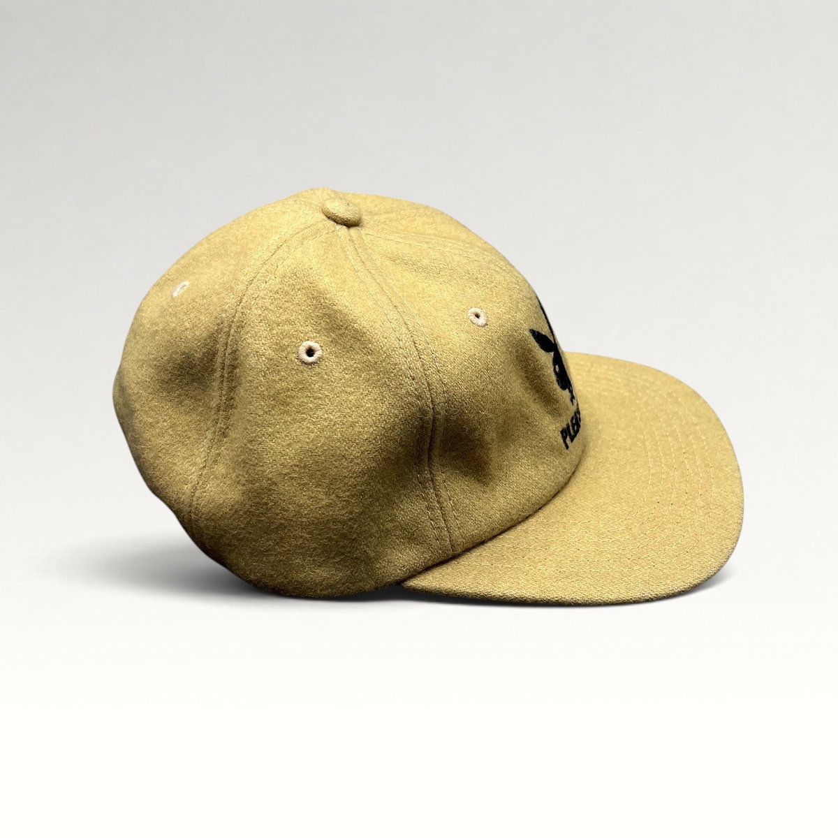 Raree Finds PLEASURES x Playboy mustard wool strapback hat with black embroidered bunny logo and curved brim