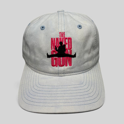 Raree Finds white cotton strapback hat featuring pink The Naked Gun embroidery and a black silhouette graphic.