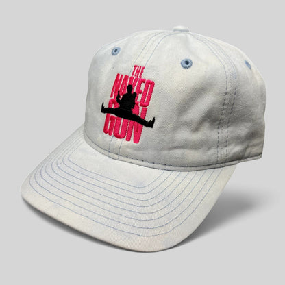 Raree Finds white cotton strapback hat with pink The Naked Gun 2025 movie embroidery and light blue stitching details.
