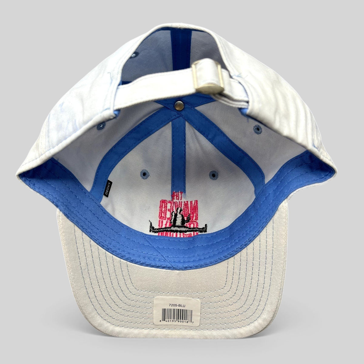 Raree Finds The Naked Gun 2025 promotional strapback hat, white cotton with pink embroidery and blue interior trim.