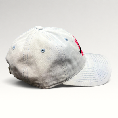 Raree Finds white cotton strapback hat with pink The Naked Gun embroidery and light blue stitching, side view.
