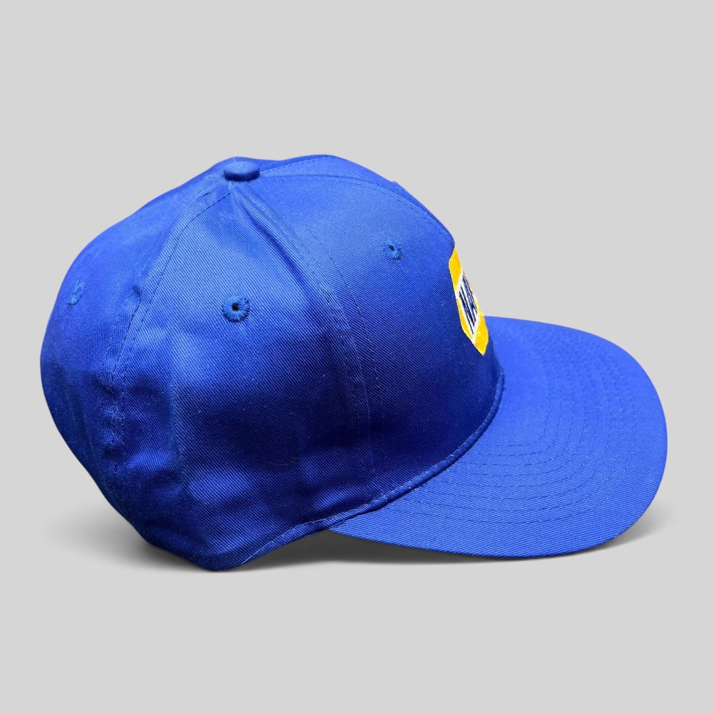 Raree Finds vintage royal blue NAPA Racing snapback hat with yellow embroidered logo on a structured 6-panel crown.