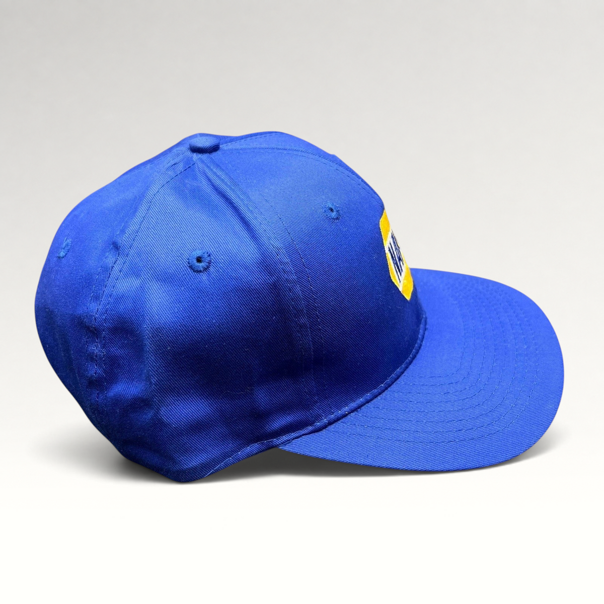 Raree Finds vintage royal blue NAPA Racing snapback hat with yellow embroidered logo on a structured 6-panel crown.