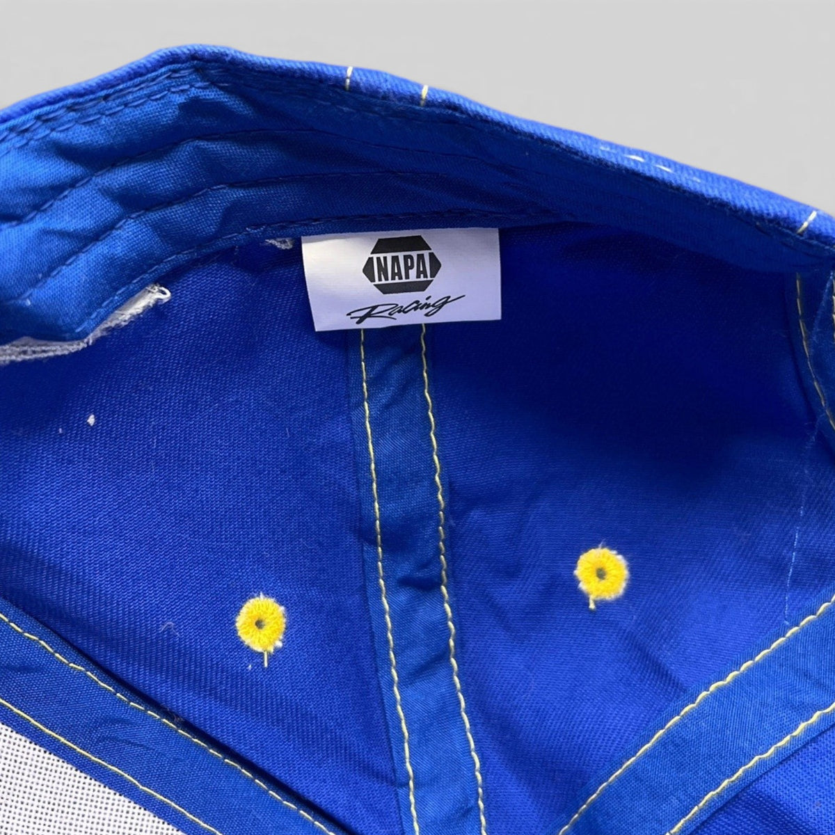 Raree Finds vintage royal blue NAPA Racing cotton hat interior with branded label and yellow stitched eyelets