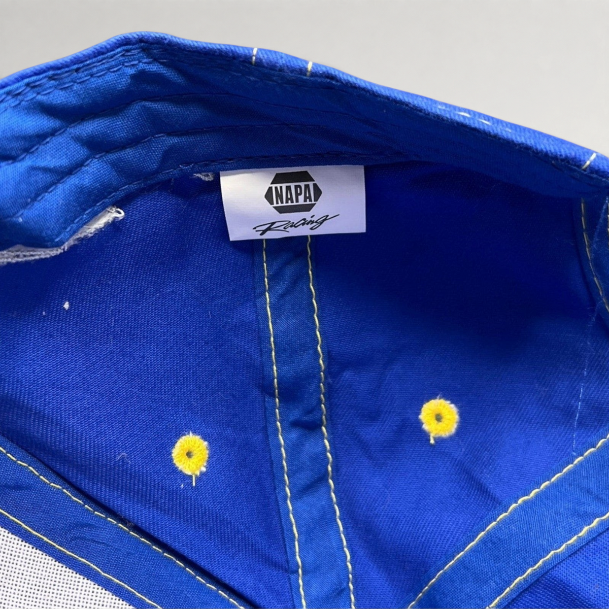 Raree Finds vintage royal blue NAPA Racing cotton hat interior with branded label and yellow stitched eyelets
