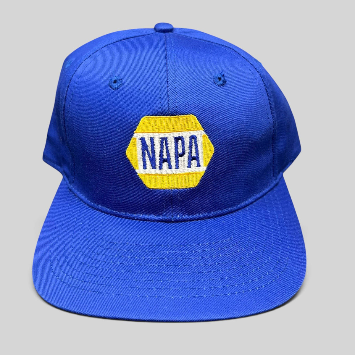 Raree Finds vintage royal blue NAPA racing snapback hat with embroidered yellow and white hex logo on front panel