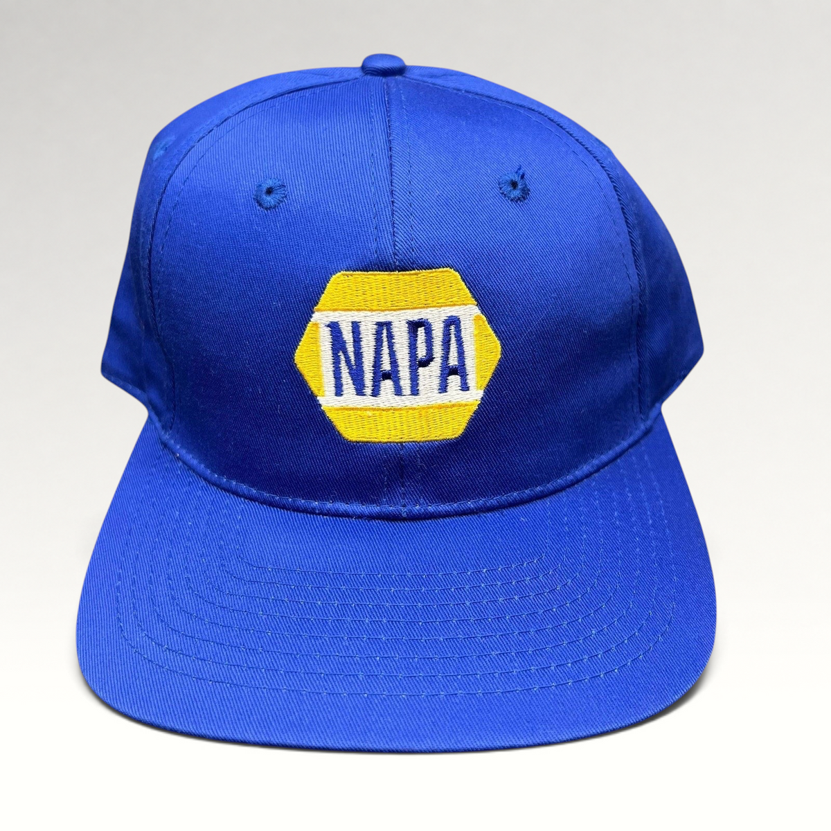 Raree Finds vintage royal blue NAPA racing snapback hat with embroidered yellow and white hex logo on front panel