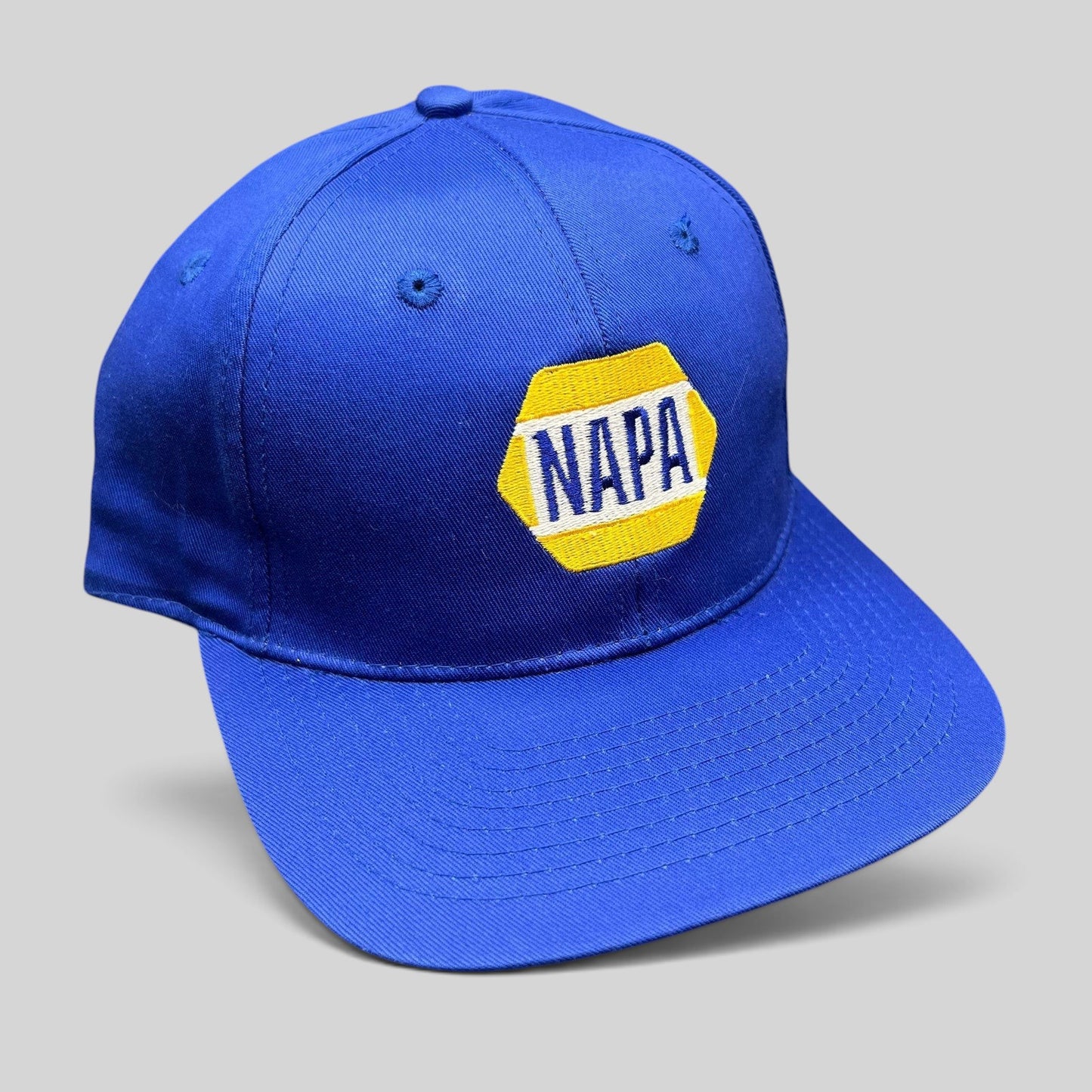 Raree Finds vintage royal blue NAPA Racing snapback hat with embroidered yellow and white hex logo on front panel
