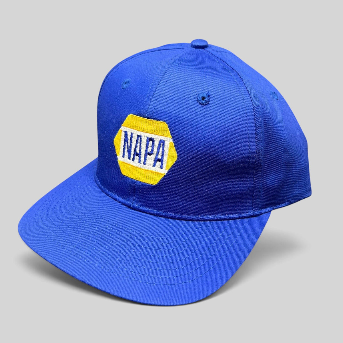 Raree Finds vintage royal blue NAPA Racing snapback hat with yellow and white embroidered hex logo on front panel