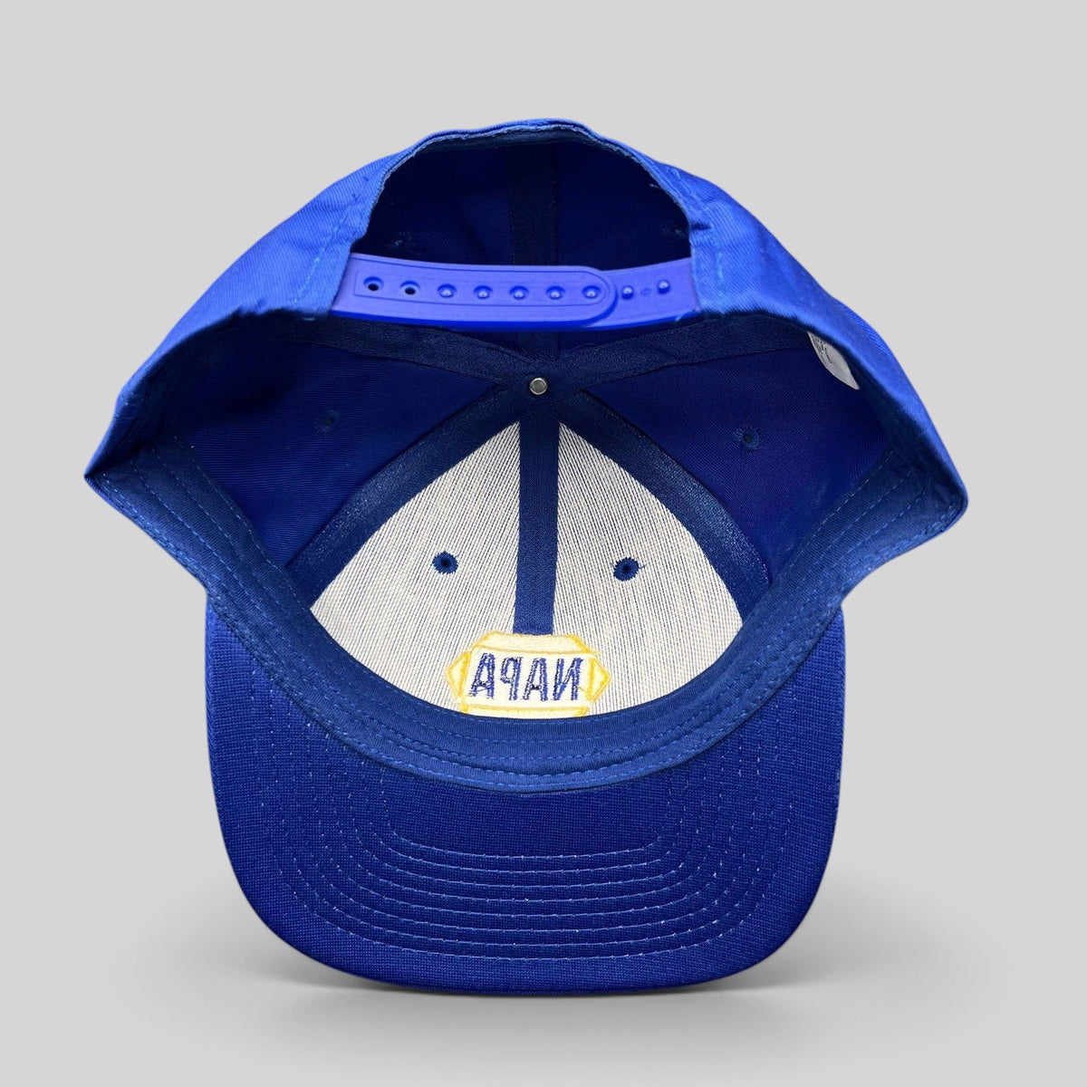 Raree Finds vintage NAPA Racing snapback hat interior view showing the blue plastic strap and embroidered logo