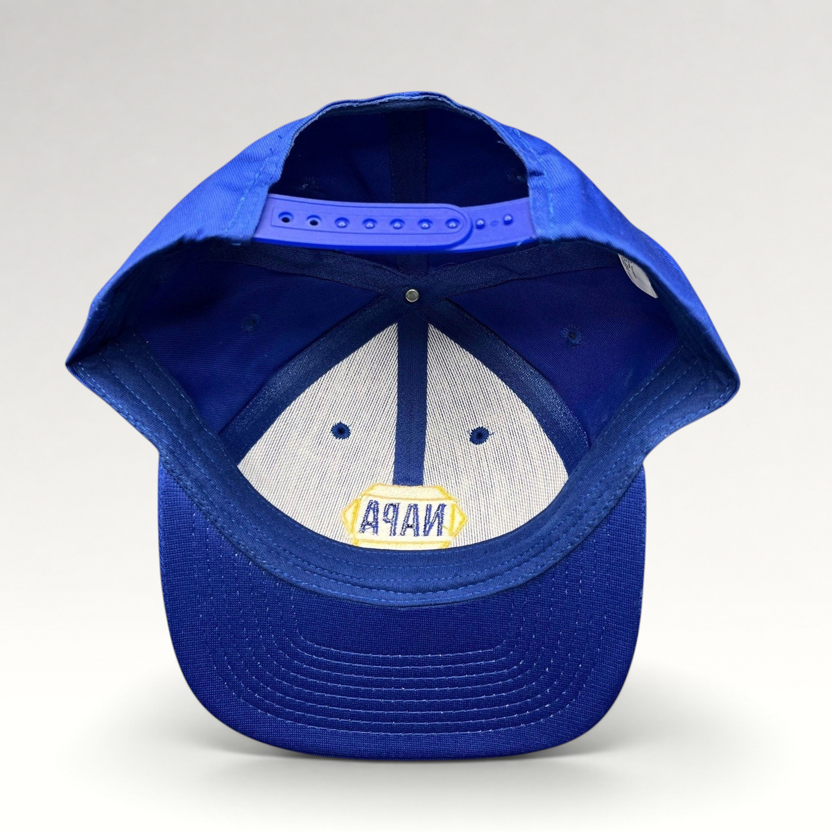 Raree Finds vintage NAPA Racing snapback hat interior view showing the blue plastic strap and embroidered logo