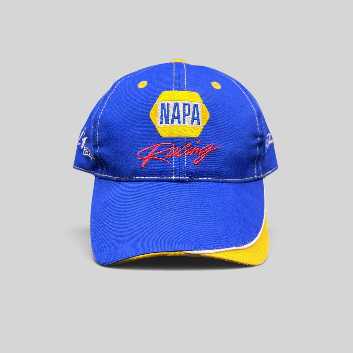 Raree Finds vintage royal blue NAPA Racing strapback hat with yellow underbrim and Ron Capps signature embroidery.